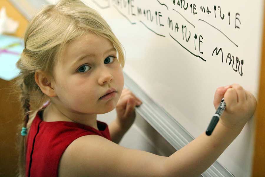 Child writing on board